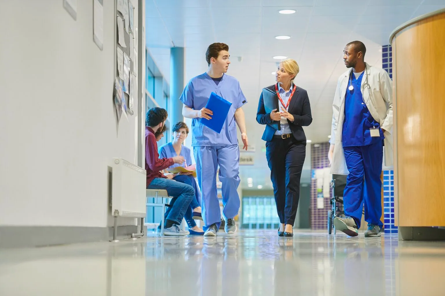 Nurse and doctor walking in hallway stock photo